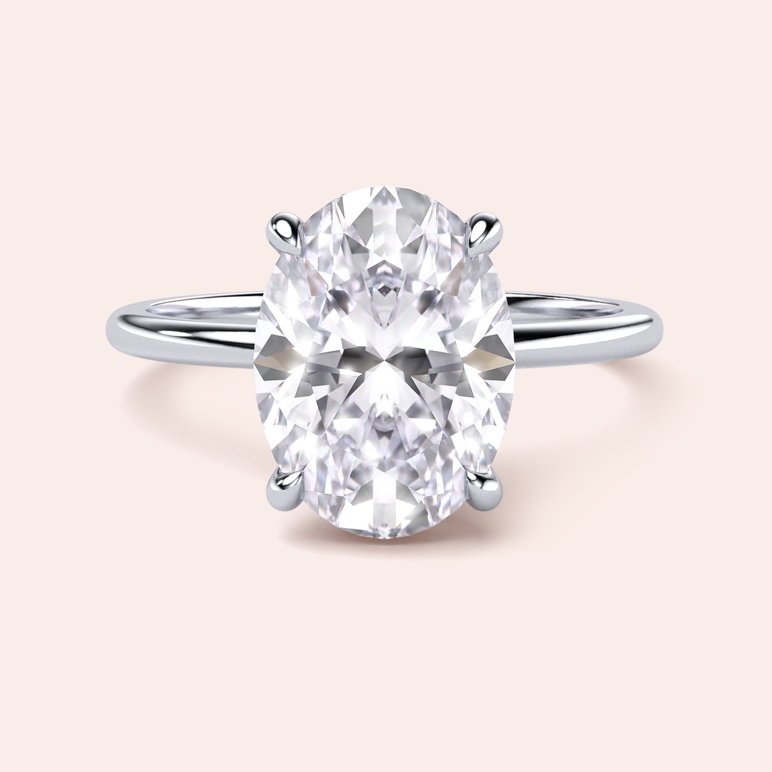 Elegant oval-cut diamond engagement ring in 14K or 18K gold or platinum, showcasing timeless beauty on a neutral background.|
#14KRecycledWhiteGold
#18KRecycledWhiteGold
#Platinum