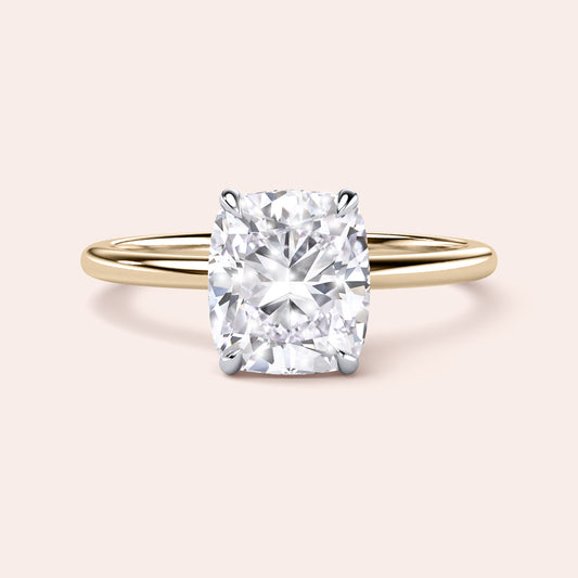 Two-tone 14K/18K gold engagement ring featuring a cushion-cut diamond in white and yellow gold.