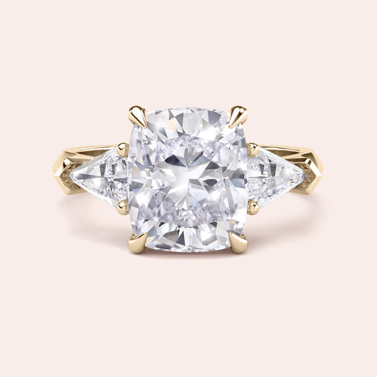 Elegant 14K yellow gold three stone engagement ring with cushion diamond centerpiece and split shank design, featuring dazzling smaller diamonds.