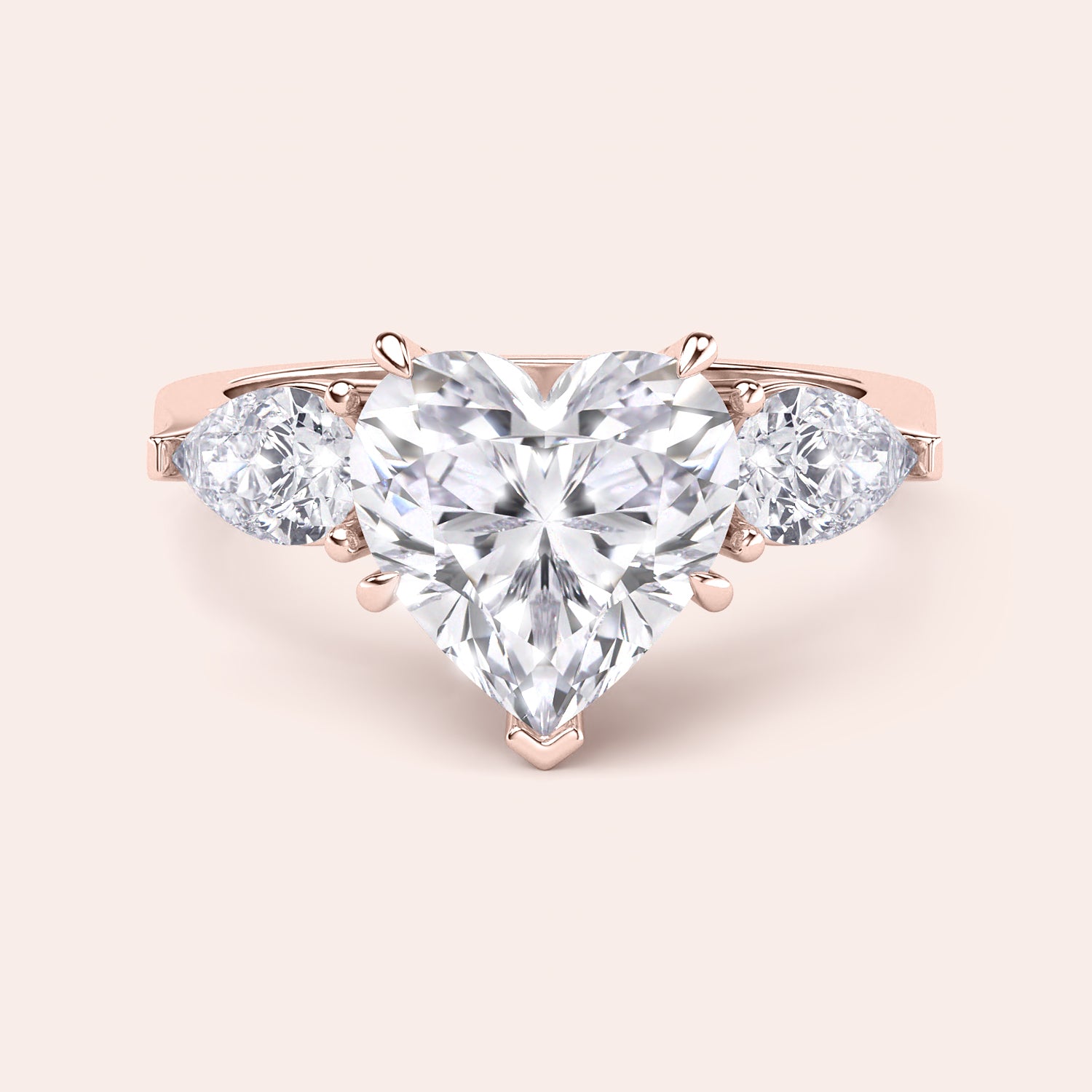 Rose gold engagement ring with a heart-shaped main diamond and elegant teardrop diamonds, designed for a luxurious and timeless proposal. | #14KRecycledRoseGold #18KRecycledRoseGold