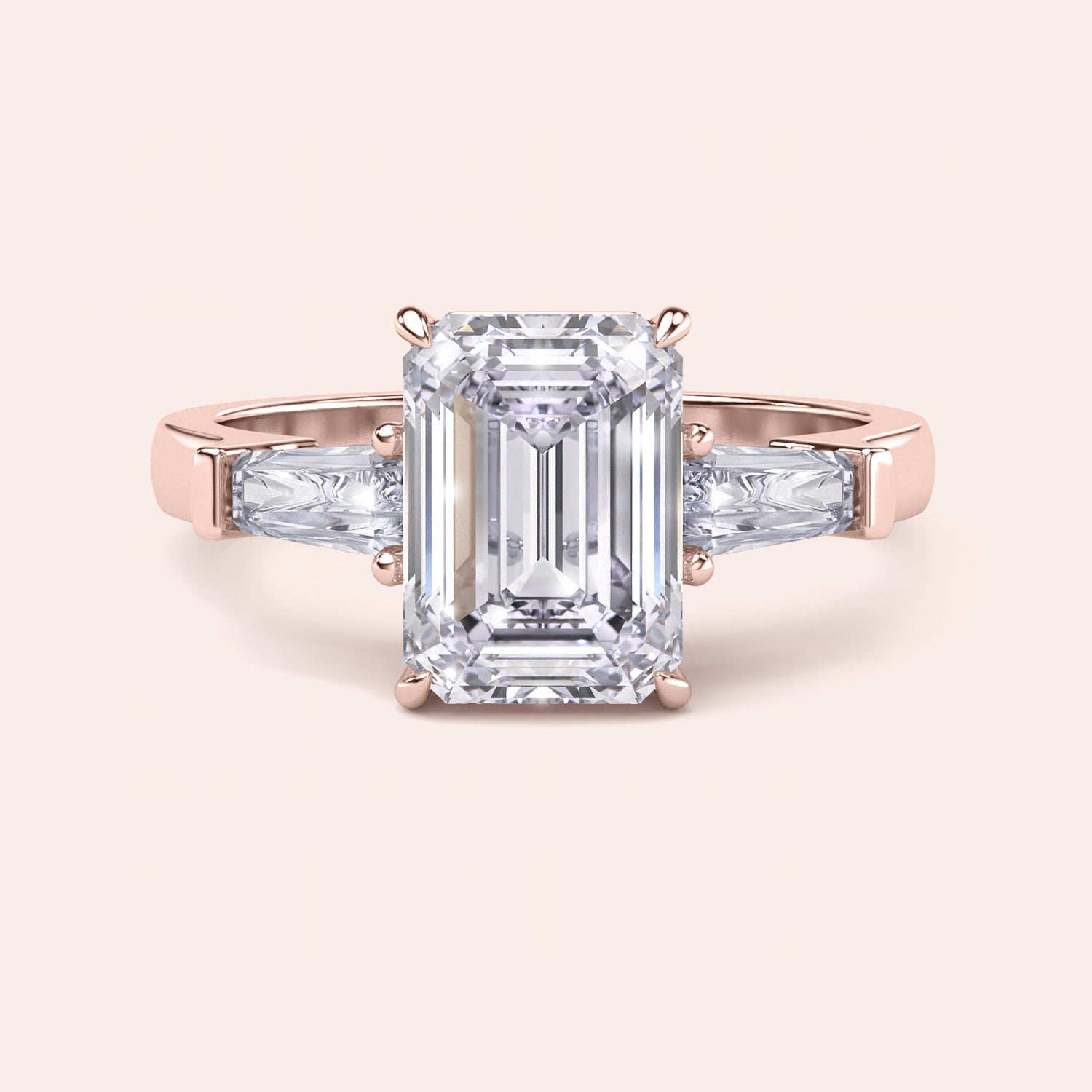 Rose gold engagement ring featuring an elongated emerald-cut diamond, set in a sleek, modern band, with ILANIS engraved inside. | #14KRecycledRoseGold #18KRecycledRoseGold
