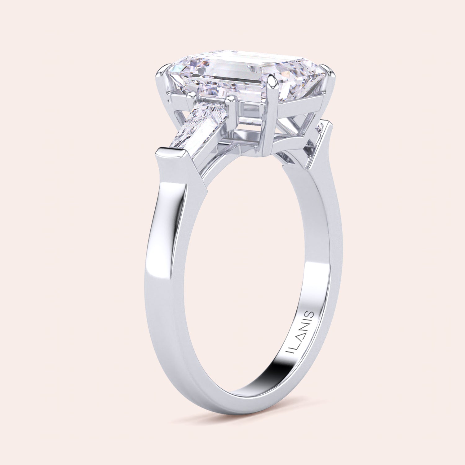 Sophisticated white gold engagement ring displaying a large emerald-cut center diamond with trapezoid side stones, enhancing its elegant design. | #14KRecycledWhiteGold #18KRecycledWhiteGold #Platinum