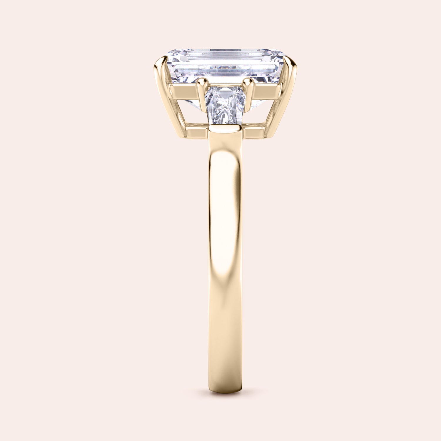 Yellow gold engagement ring featuring an elongated emerald-cut diamond, set in a sleek, modern band, with ILANIS engraved inside. | #14KRecycledYellowGold #18KRecycledYellowGold