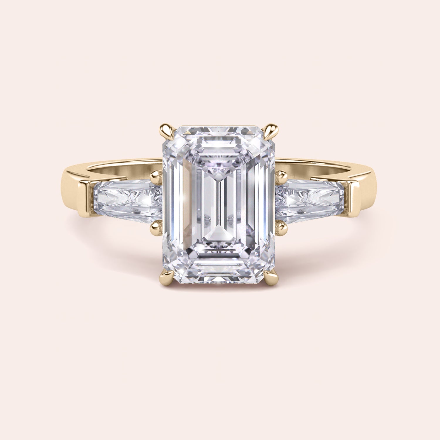 Yellow gold engagement ring featuring a prominent emerald-cut diamond, flanked by smaller diamonds on a delicate band, exuding luxury. | 
#14KRecycledYellowGold #18KRecycledYellowGold