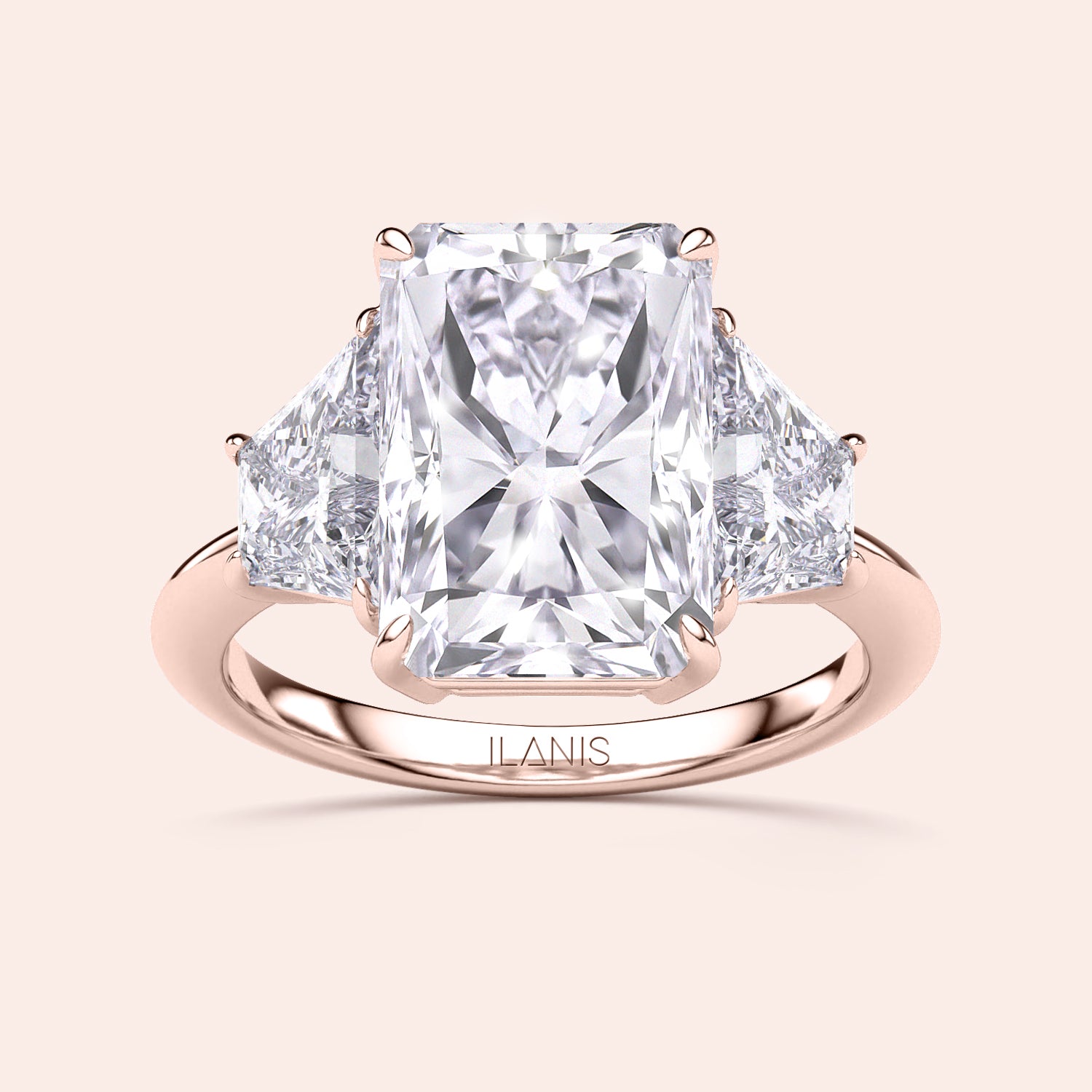 Elegant 14K or 18K rose gold three-stone engagement ring with a radiant-cut diamond and triangular side stones.|
#14KRecycledRoseGold
#18KRecycledRoseGold