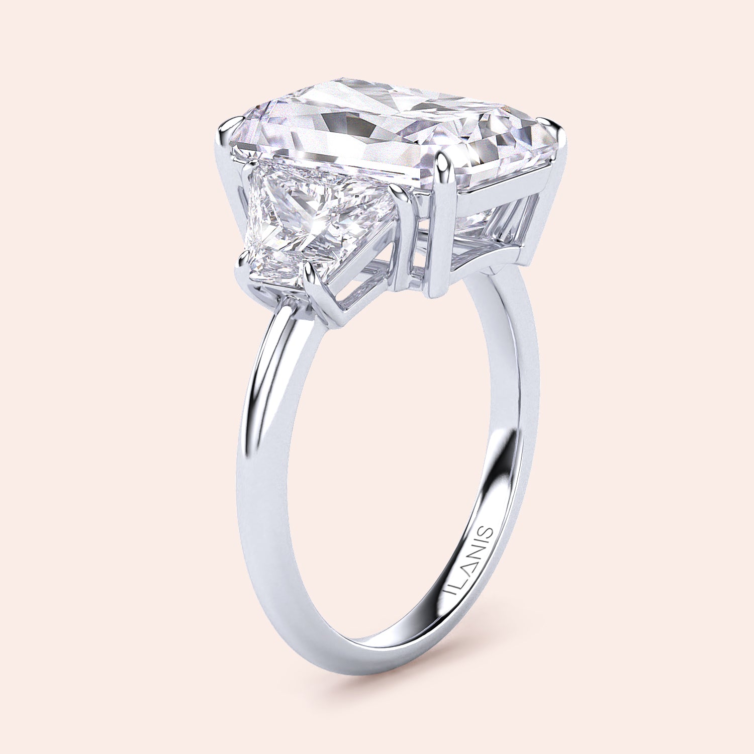 Elegant 14K/18K platinum engagement ring with a radiant three-stone design, featuring an emerald-cut diamond and trapezoid accents.|
#14KRecycledWhiteGold
#18KRecycledWhiteGold
#Platinum
