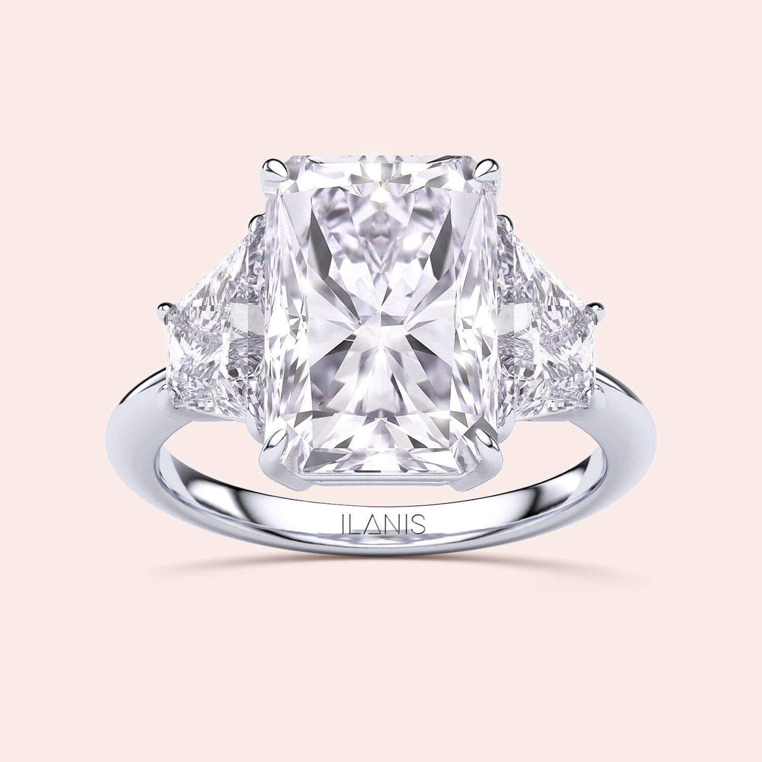 Radiant three-stone engagement ring in 14K white gold, featuring a radiant-cut diamond flanked by brilliant triangular diamonds.|
#14KRecycledWhiteGold
#18KRecycledWhiteGold
#Platinum