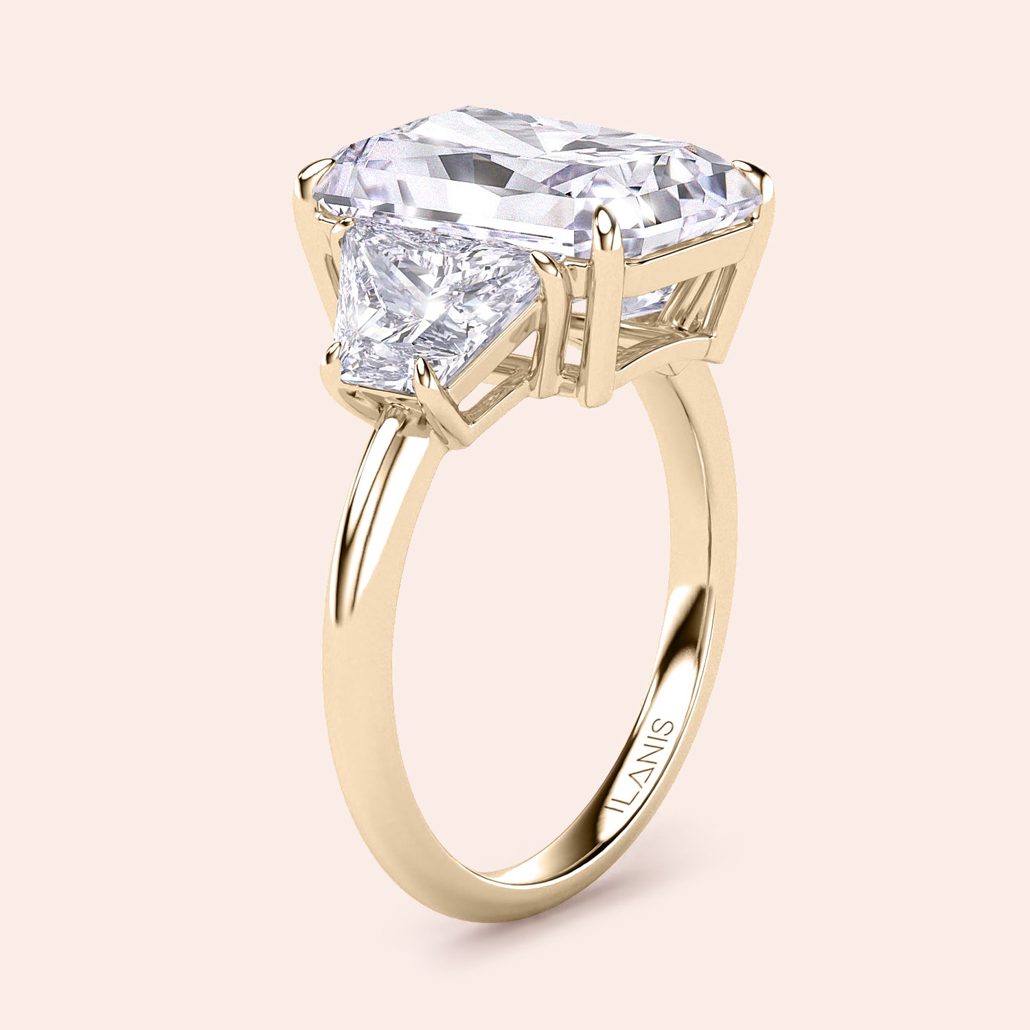 Elegant 14K yellow gold engagement ring featuring a radiant-cut diamond center and trapezoid side stones, showcasing luxury and brilliance.|
#14KRecycledYellowGold
#18KRecycledYellowGold