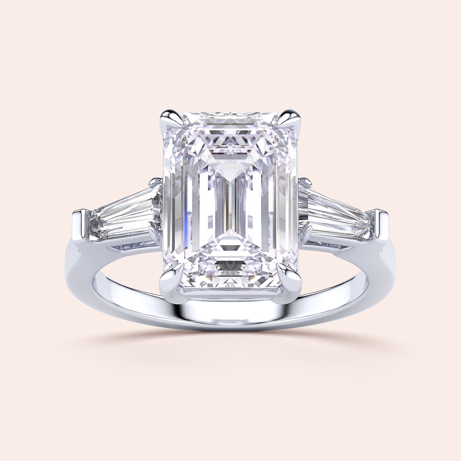 Elegant engagement ring with emerald-cut diamond and tapered baguette side stones, available in 14K or 18K gold, or platinum.|
#14KRecycledWhiteGold
#18KRecycledWhiteGold
#Platinum