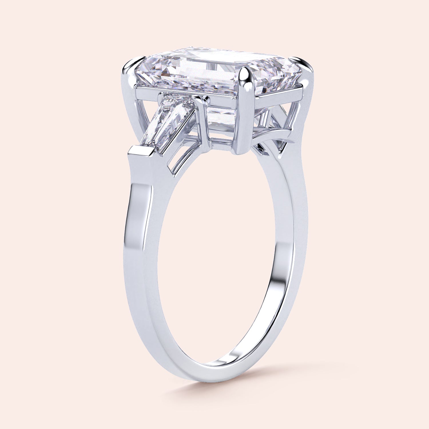 Elegant emerald-cut diamond ring featuring three tapered baguettes, crafted in 14K or 18K white gold or platinum.|
#14KRecycledWhiteGold
#18KRecycledWhiteGold
#Platinum