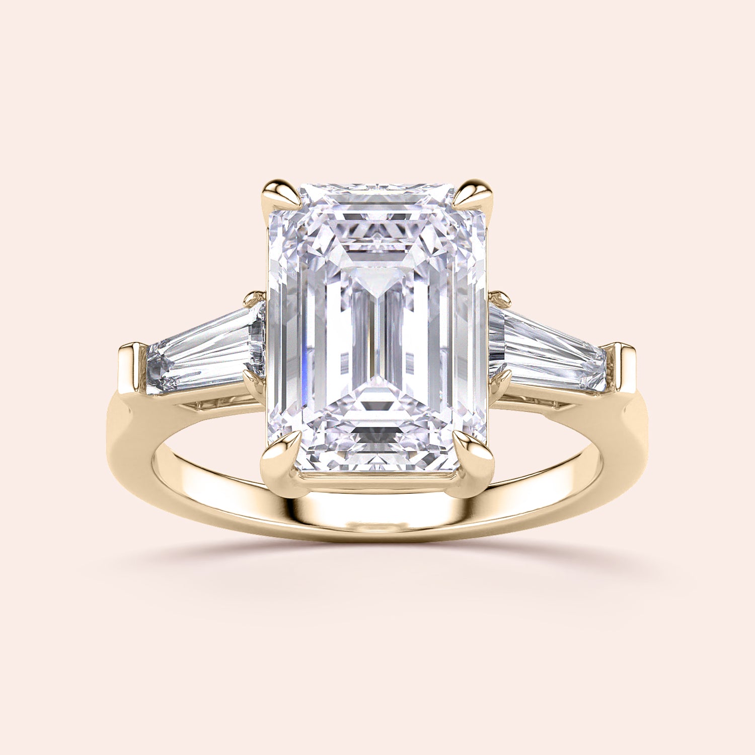 Elegant 14K yellow gold engagement ring featuring an emerald-cut diamond center stone and two tapered baguette diamonds.|
#14KRecycledYellowGold
#18KRecycledYellowGold