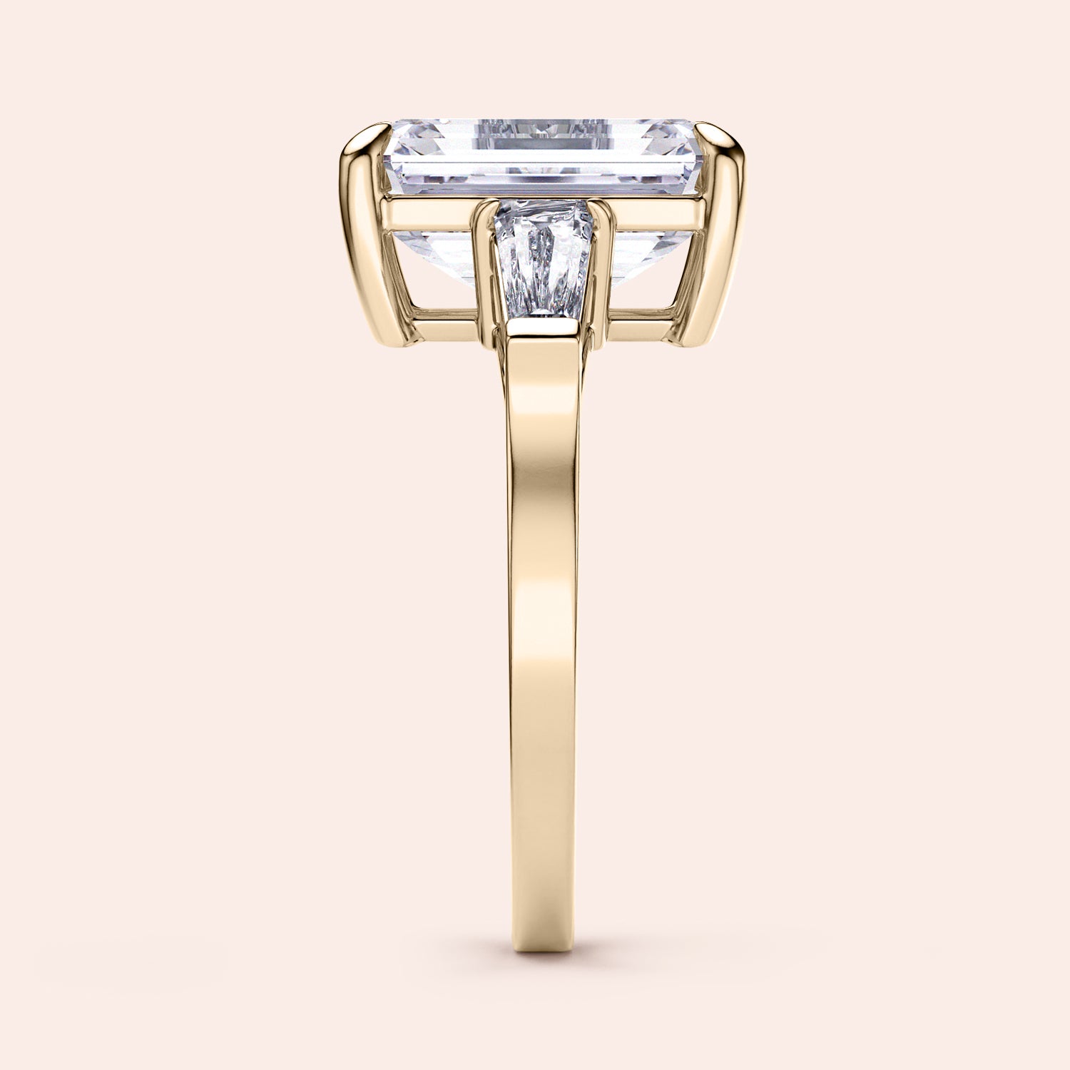 Elegant 14K or 18K gold engagement ring with emerald-cut diamond and tapered baguettes, showcasing timeless sophistication.|
#14KRecycledYellowGold
#18KRecycledYellowGold