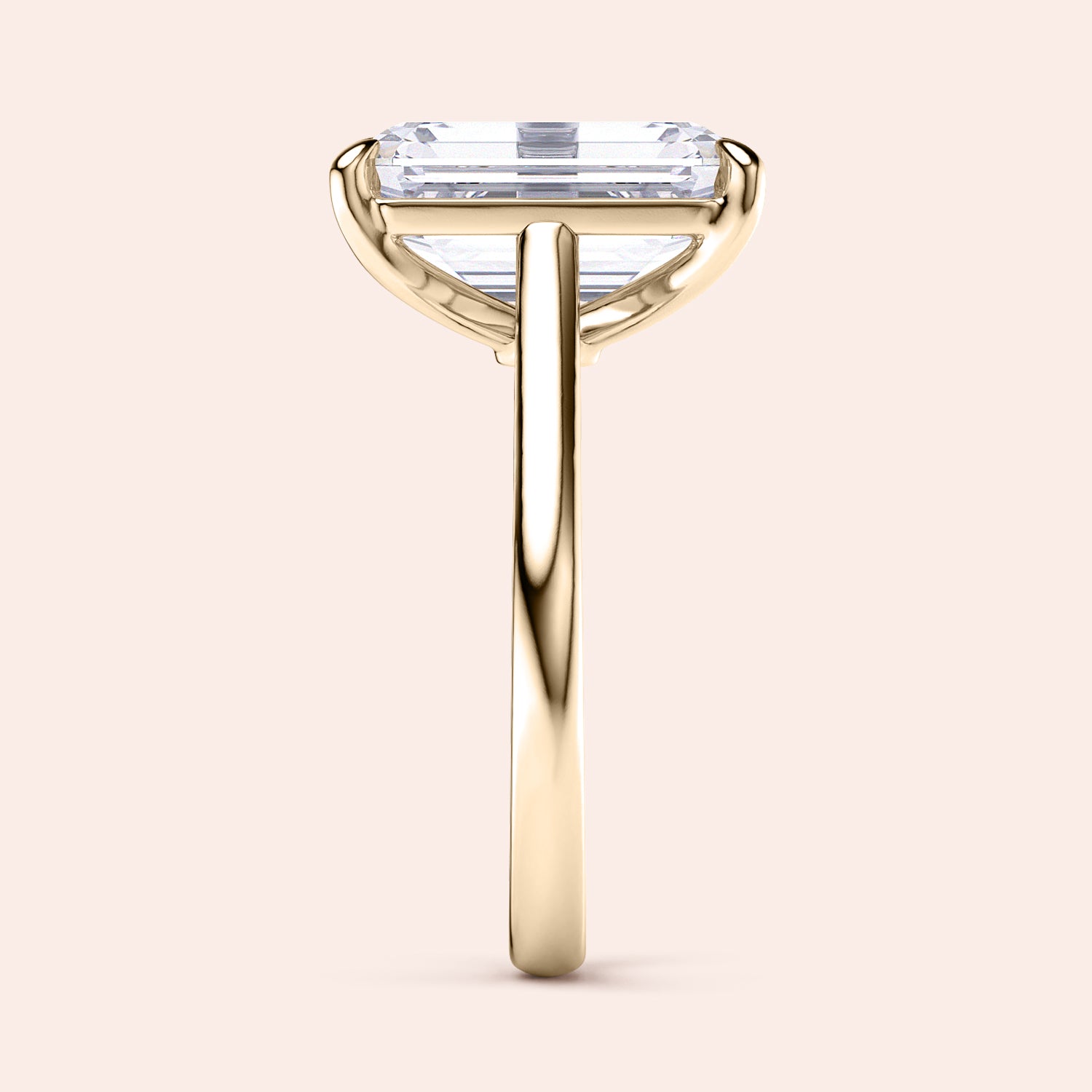 Elegant 14K or 18K gold engagement ring featuring an emerald-cut diamond, showcased in profile view on a neutral background.|
#14KRecycledYellowGold
#18KRecycledYellowGold
