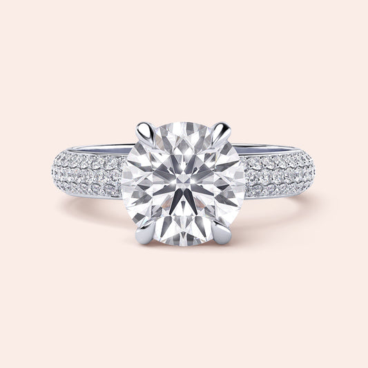 Elegant round diamond engagement ring withPave-set band in 14K, 18K, or platinum. Perfect for a timeless proposal.