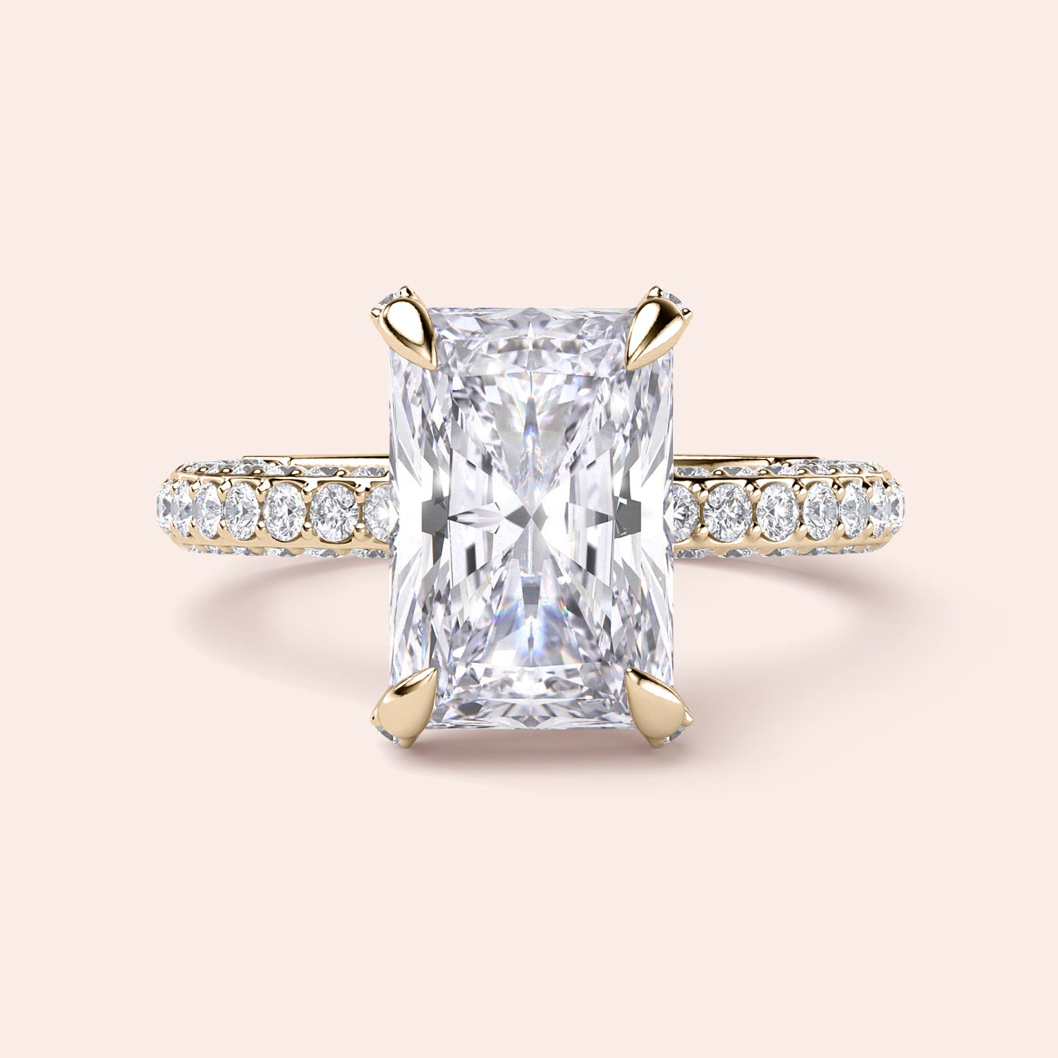 Radiant-cut diamond engagement ring with side stone accents in 14K yellow gold, displayed on a neutral background.|
#14KRecycledYellowGold
#18KRecycledYellowGold