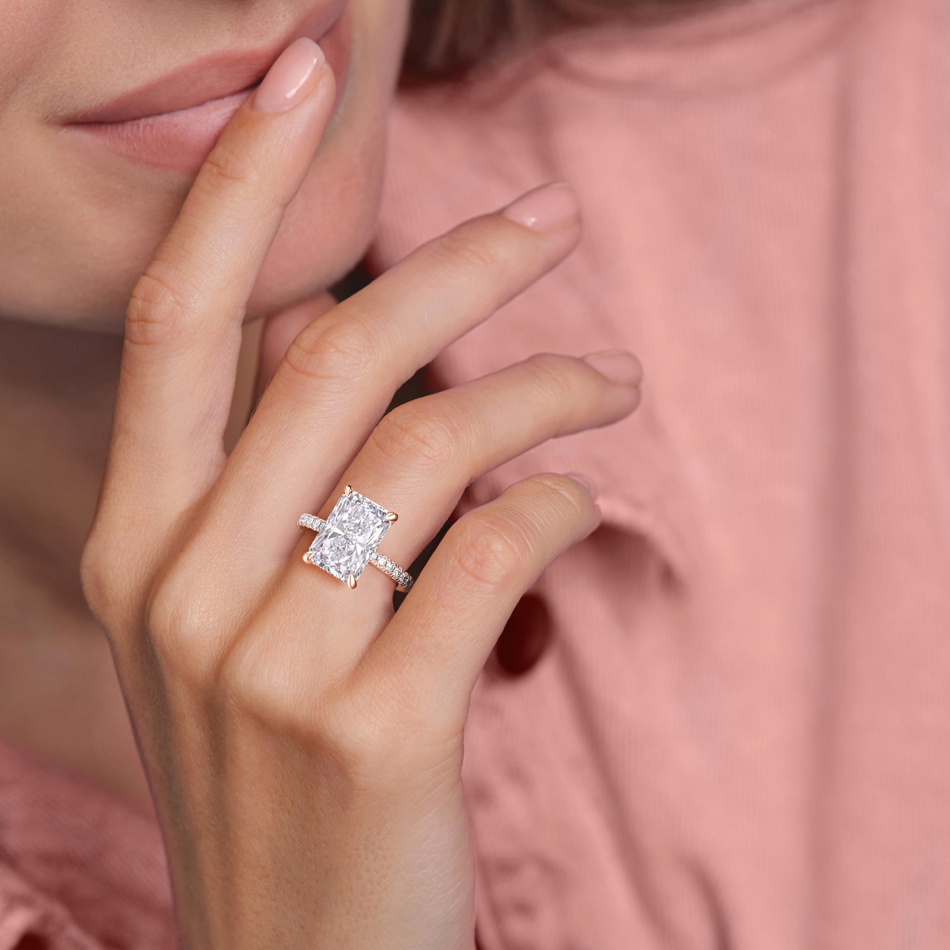 Close-up of a woman's hands showcasing a radiant cut diamond engagement ring in a 14K rose gold band, accentuating elegance.|
#14KRecycledRoseGold
#18KRecycledRoseGold