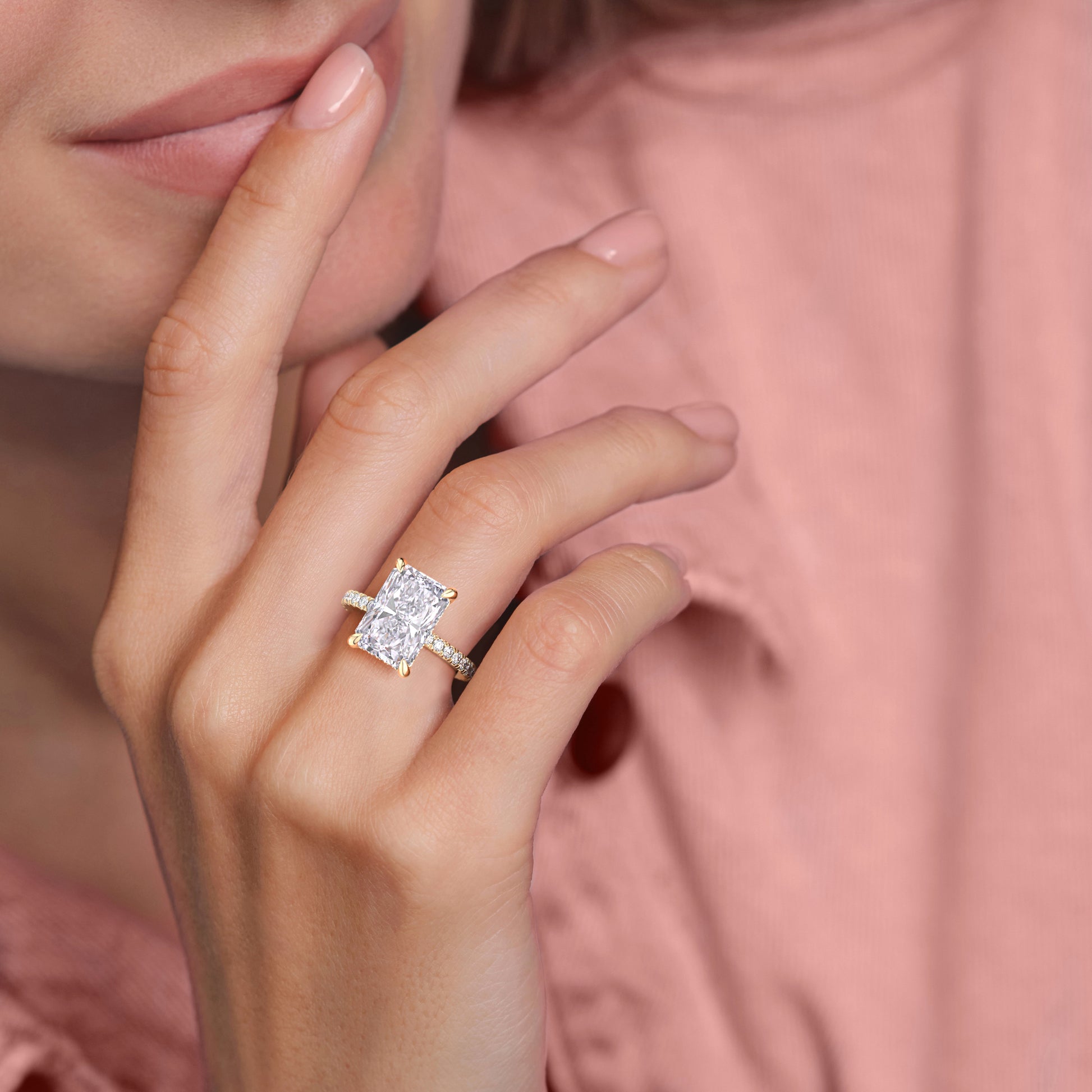 Elegant 14K yellow gold engagement ring featuring a radiant cut diamond on a model's hand, showcasing its hidden halo design.|
#14KRecycledYellowGold
#18KRecycledYellowGold