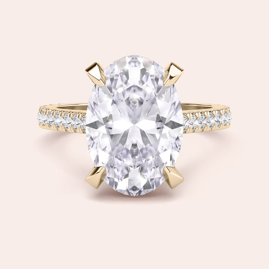 Radiant-cut diamond engagement ring with side stone accents in 14K yellow gold, displayed on a neutral background.