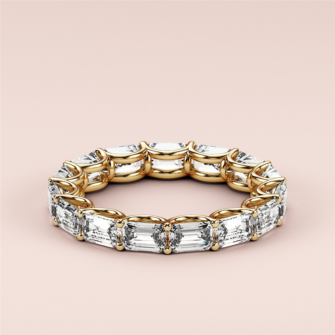 Elegant emerald-cut diamond eternity wedding band in 14K or 18K yellow gold, showcasing luxurious sparkle and intricate design. |
 
 
 #14KRecycledYellowGold
 #18KRecycledYellowGold