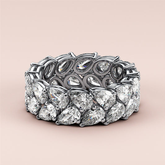 Elegant 14K or 18K gold or platinum eternity wedding band set with brilliant oval-shaped diamonds on a neutral background.
