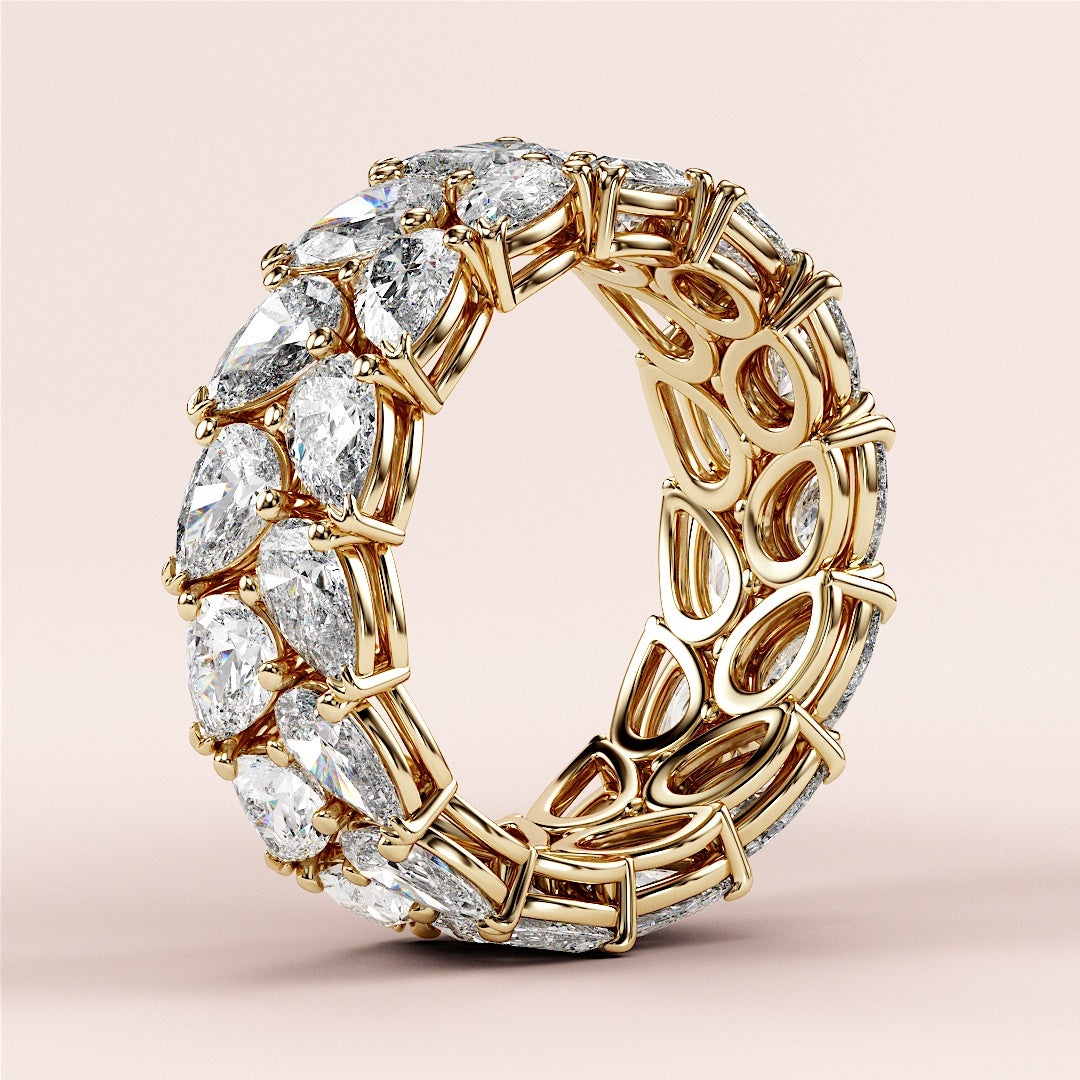 Elegant 14K or 18K gold wedding band featuring pear-shaped diamonds in a two-row eternity design, showcasing exquisite craftsmanship. |
 
 
 #14KRecycledYellowGold
 #18KRecycledYellowGold