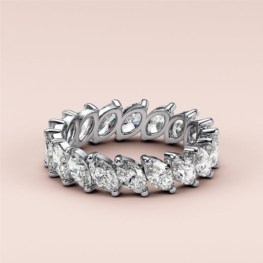 14K and 18K white gold eternity band featuring marquise-cut diamonds, a luxurious wedding band set against a neutral background.