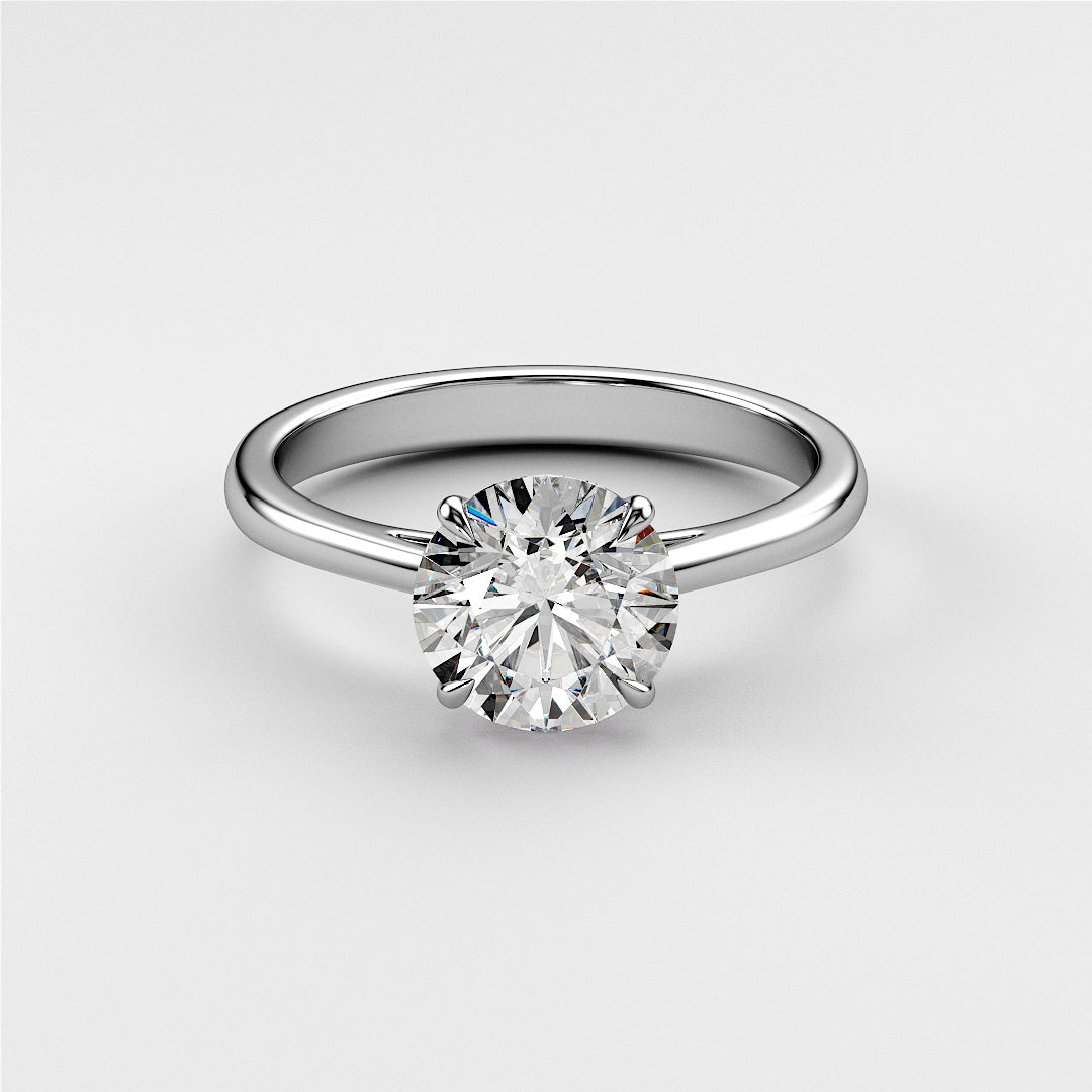"Elegant 14K or 18K white gold solitaire engagement ring with round-cut diamond in a polished cathedral setting."|
#14KRecycledWhiteGold
#18KRecycledWhiteGold
#Platinum