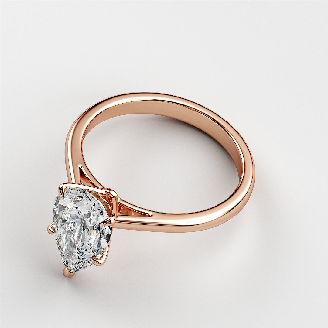 Rose gold engagement ring featuring a pear-shaped diamond, available in 14K, 18K, or platinum, perfect for timeless elegance.|
#14KRecycledRoseGold
#18KRecycledRoseGold