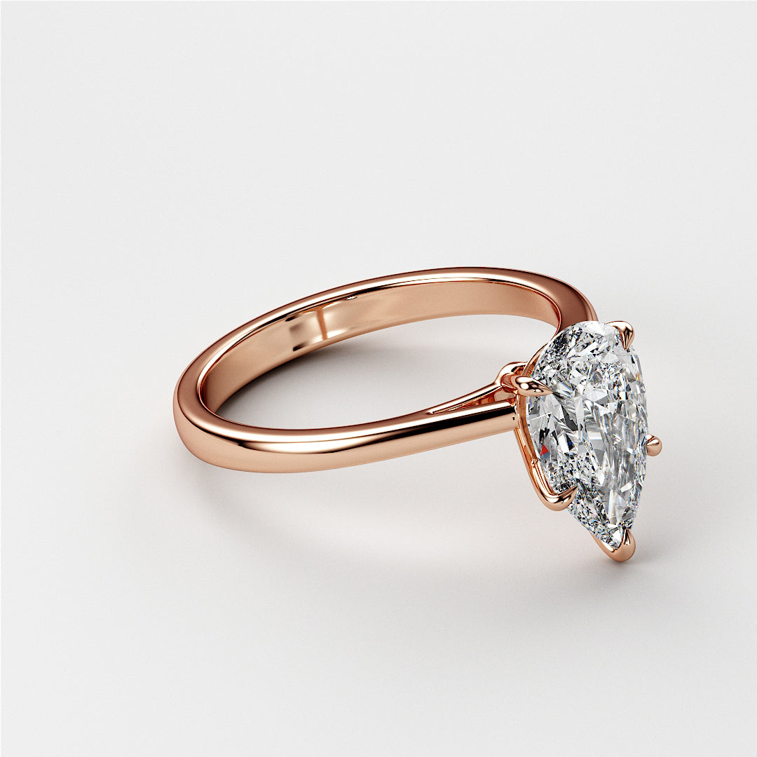 Exquisite pear-shaped diamond engagement ring in sleek 14K rose gold band, perfect for special occasions.|
#14KRecycledRoseGold
#18KRecycledRoseGold