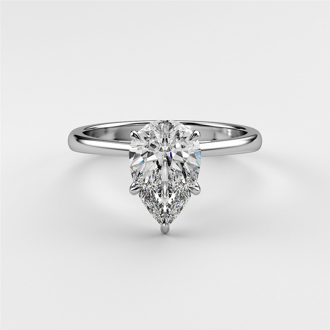 Elegant pear-shaped diamond engagement ring in 14K or 18K white gold, classic solitaire design on a white background.|
#14KRecycledWhiteGold
#18KRecycledWhiteGold
#Platinum