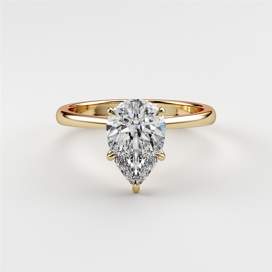 Elegant 14K and 18K yellow gold engagement ring featuring a pear-shaped diamond, showcased on a model.|
#14KRecycledYellowGold
#18KRecycledYellowGold