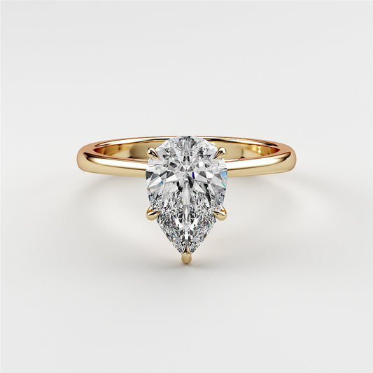 Elegant 14K and 18K yellow gold engagement ring featuring a pear-shaped diamond, showcased on a model.