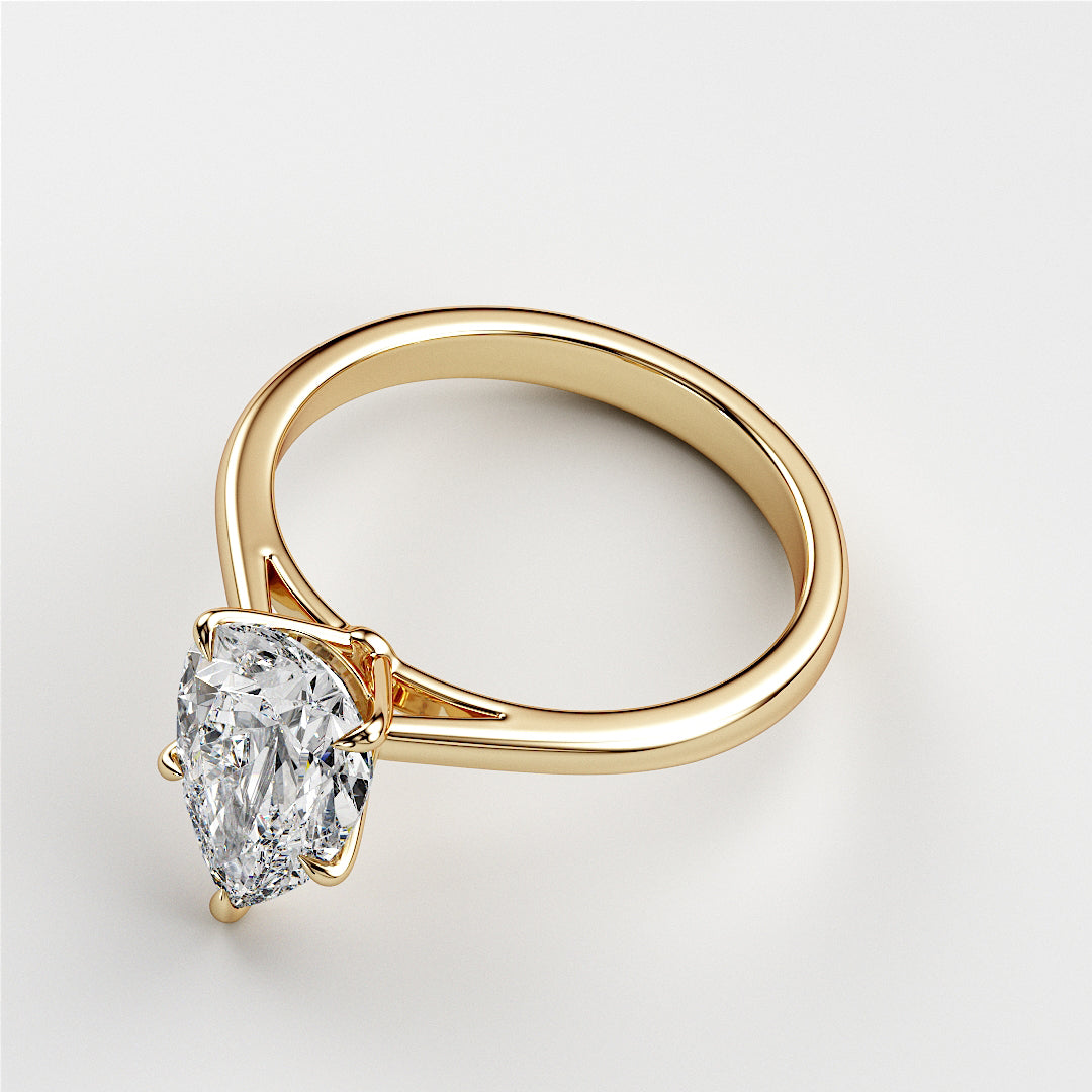 Elegant pear-shaped diamond engagement ring in 14K or 18K gold, showcasing exquisite clarity in a classic solitaire design.|
#14KRecycledYellowGold
#18KRecycledYellowGold