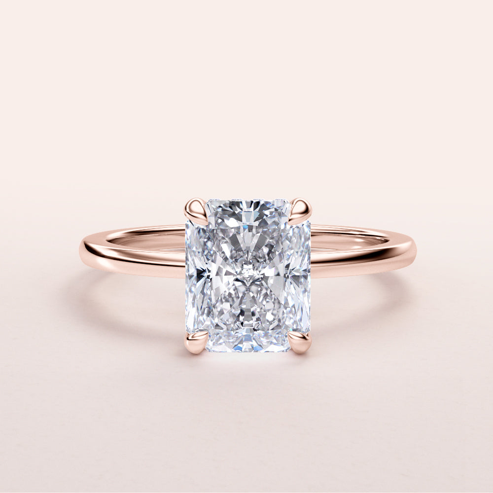 Radiant-cut diamond engagement ring in 14K rose gold, featuring a stunning halo and elegant solitaire design.|
#14KRecycledRoseGold
#18KRecycledRoseGold