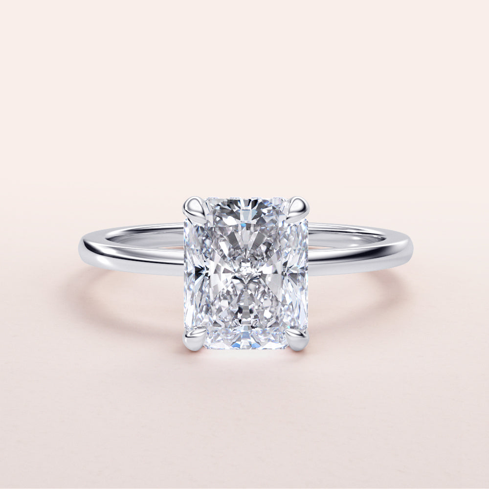 Elegant radiant-cut diamond engagement ring in 14K or 18K white gold, featuring a simple band and hidden halo design.|
#14KRecycledWhiteGold
#18KRecycledWhiteGold
#Platinum