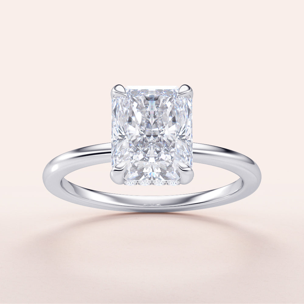 "Radiant cut diamond solitaire ring in 14K white gold, featuring a hidden halo and plain band, perfect for elegant engagements."|
#14KRecycledWhiteGold
#18KRecycledWhiteGold
#Platinum