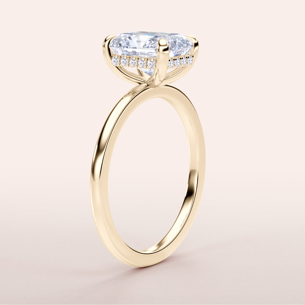 Elegant 14K yellow gold engagement ring with a radiant diamond center stone and delicate halo of smaller diamonds.|
#14KRecycledYellowGold
#18KRecycledYellowGold