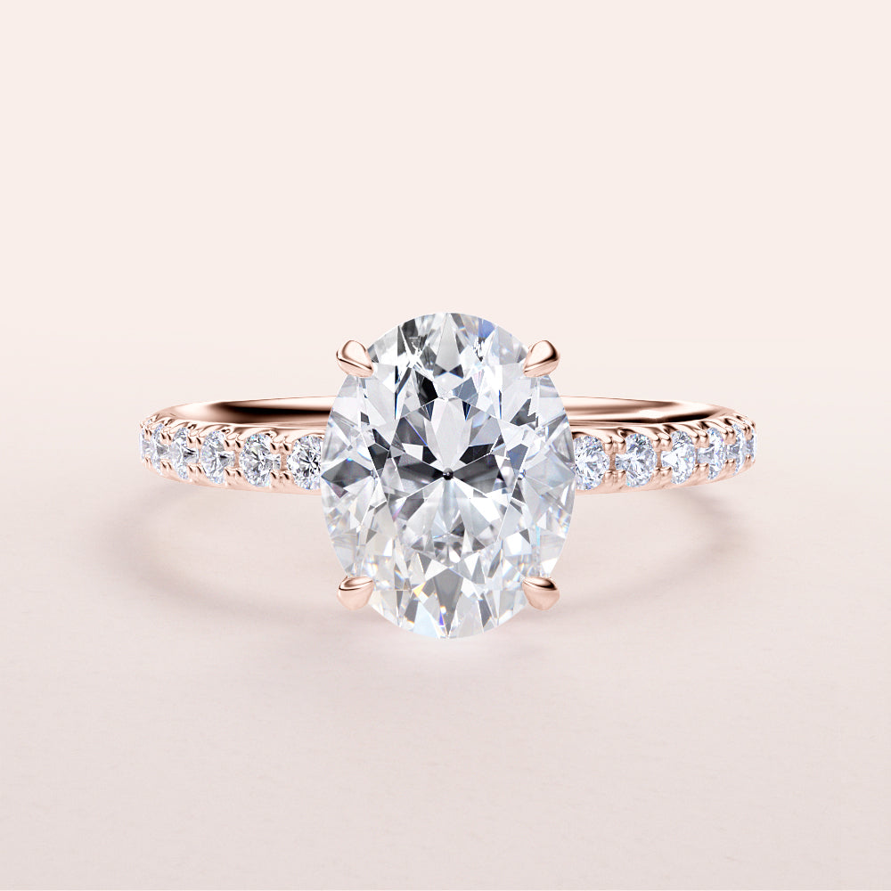 Elegant 14K Rose Gold oval engagement ring with hidden halo, prong accents, and a pave diamond band for timeless beauty.|
#14KRecycledRoseGold
#18KRecycledRoseGold