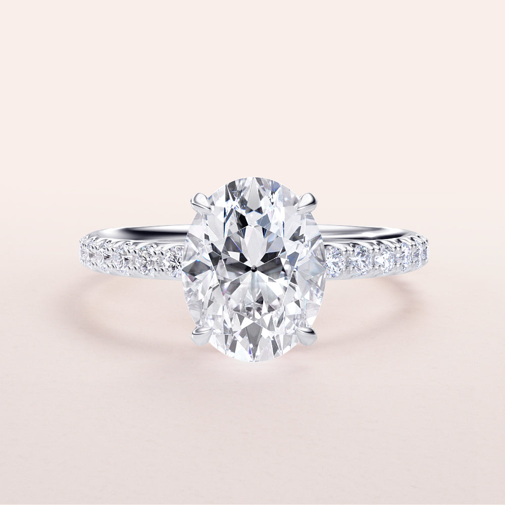 Elegant oval diamond engagement ring with a pave band in 14K, 18K gold or platinum, showcasing hidden halo and prong accents.|
#14KRecycledWhiteGold
#18KRecycledWhiteGold
#Platinum
