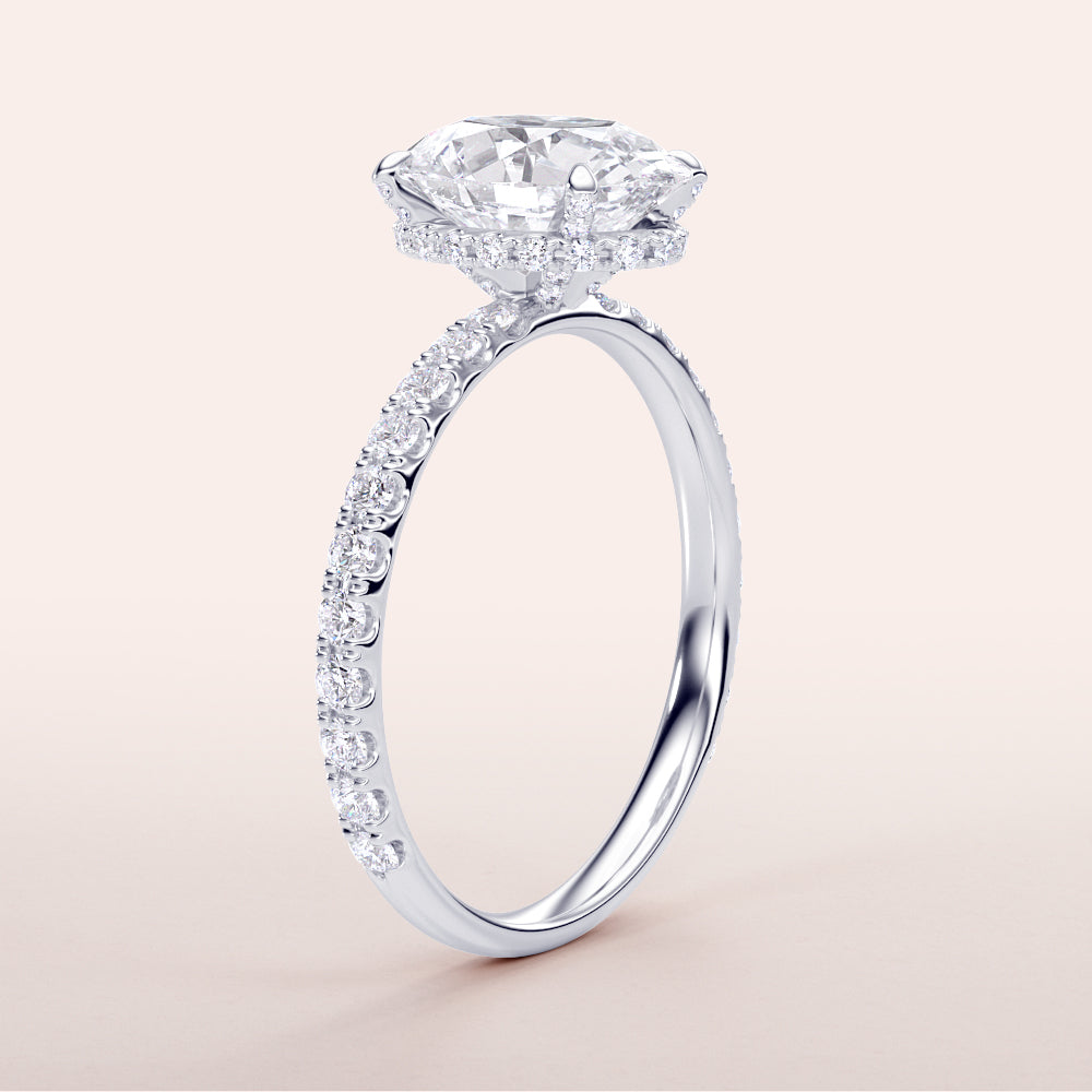 Radiant 14K or 18K white gold engagement ring featuring an oval diamond with hidden halo and pave band accents.|
#14KRecycledWhiteGold
#18KRecycledWhiteGold
#Platinum