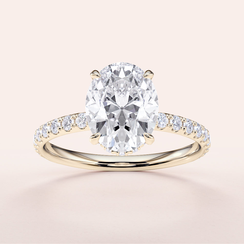 14K yellow gold engagement ring featuring an oval diamond center stone and diamond-accented pave band, on a neutral background.|
#14KRecycledYellowGold
#18KRecycledYellowGold