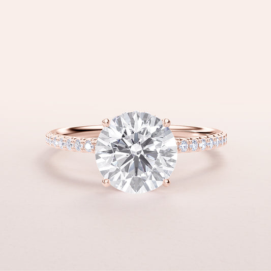 Elegant rose gold engagement ring featuring a round cut diamond andPave band, available in 14K, 18K, or platinum.