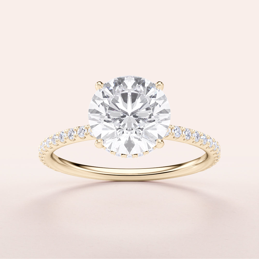 Elegant 14K yellow gold engagement ring with round brilliant diamond, set in aPave band for a timeless statement.|
#14KRecycledYellowGold
#18KRecycledYellowGold