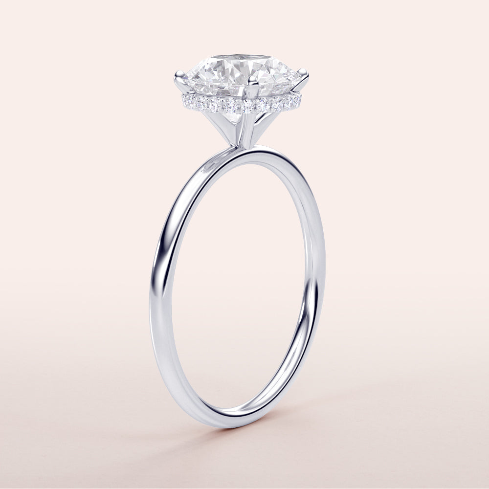 14K/18K white gold engagement ring featuring a marquise-cut diamond with a halo of smaller diamonds on a neutral background.|
#14KRecycledWhiteGold
#18KRecycledWhiteGold
#Platinum