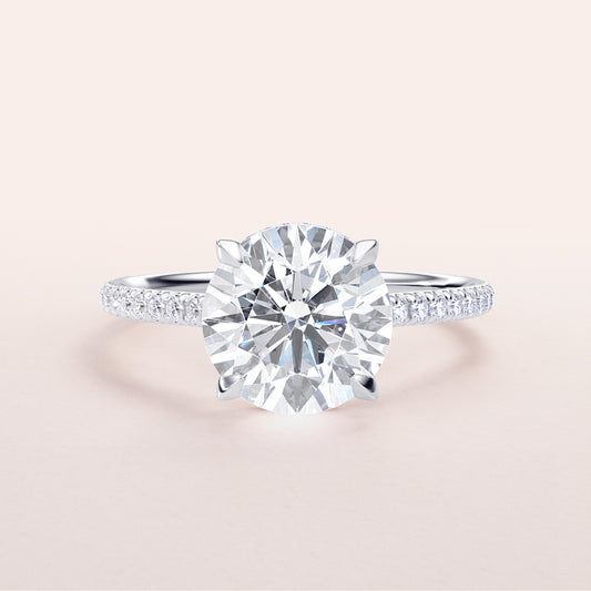 Stunning 14K or 18K white gold round diamond engagement ring with pave band, perfect for special occasions and engagements.