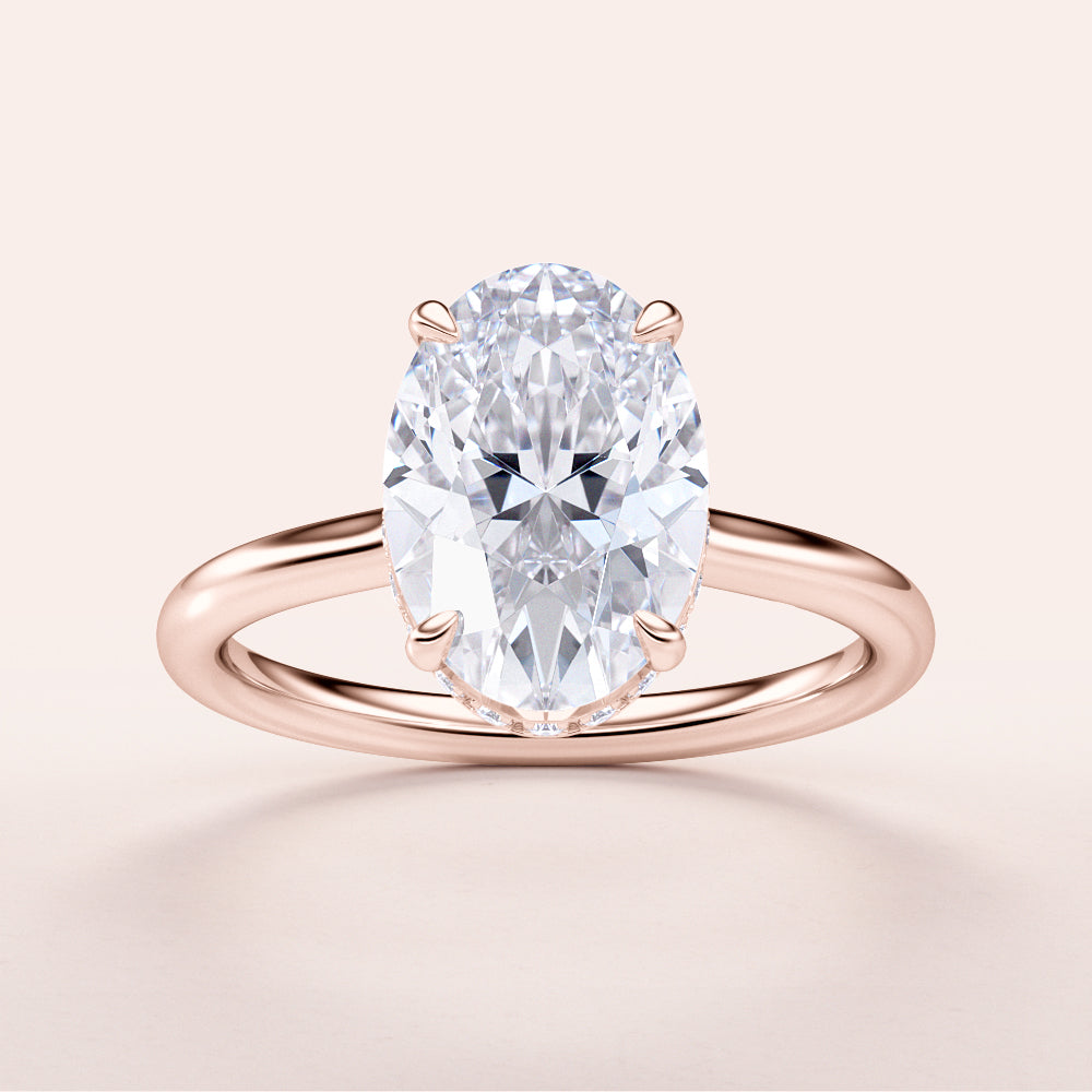 Elegant oval diamond engagement ring in rose gold, 14K and 18K options available, set in a polished band. Not worn on model.|
#14KRecycledRoseGold
#18KRecycledRoseGold
