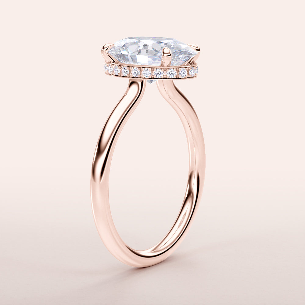 Elegant oval diamond solitaire engagement ring in 14K or 18K rose gold, featuring a hidden halo and plain band.|
#14KRecycledRoseGold
#18KRecycledRoseGold
