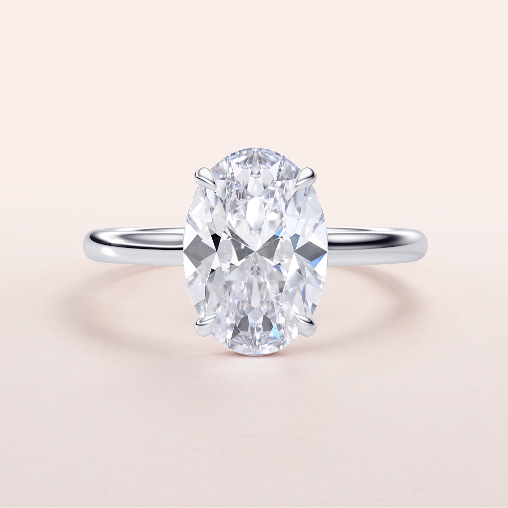Luxurious 14K/18K gold or platinum engagement ring featuring an exquisite oval-shaped diamond on a neutral background.|
#14KRecycledWhiteGold
#18KRecycledWhiteGold
#Platinum