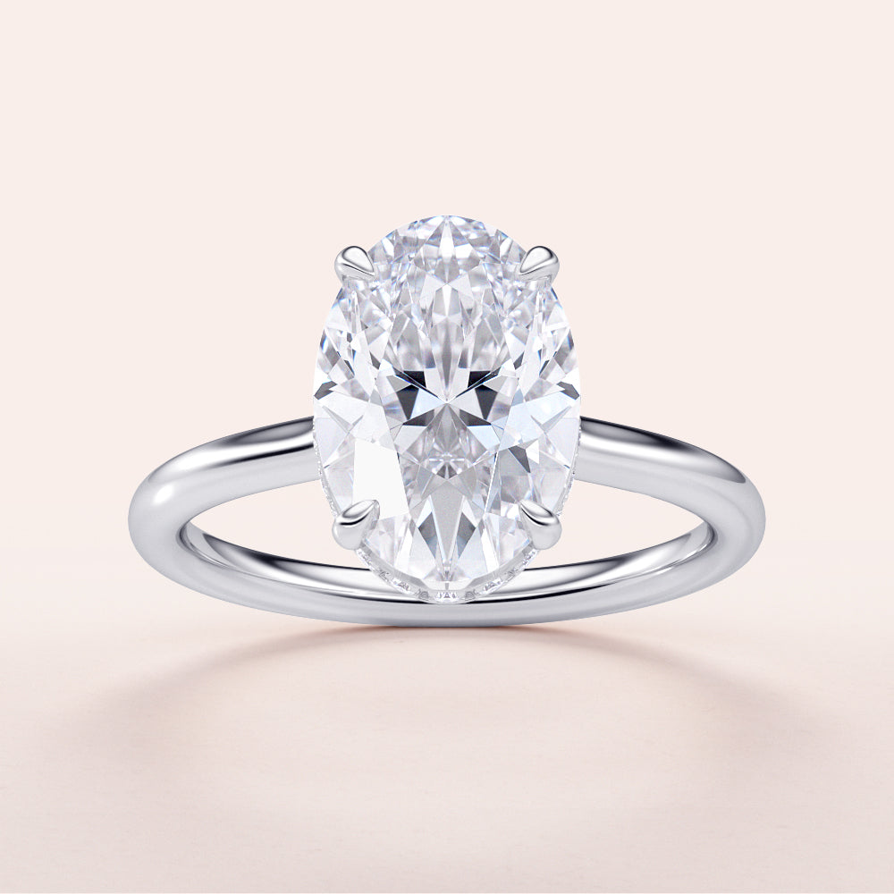Elegant oval-cut diamond engagement ring in 14K/18K gold or platinum, featuring a sleek band and a hidden halo setting.|
#14KRecycledWhiteGold
#18KRecycledWhiteGold
#Platinum