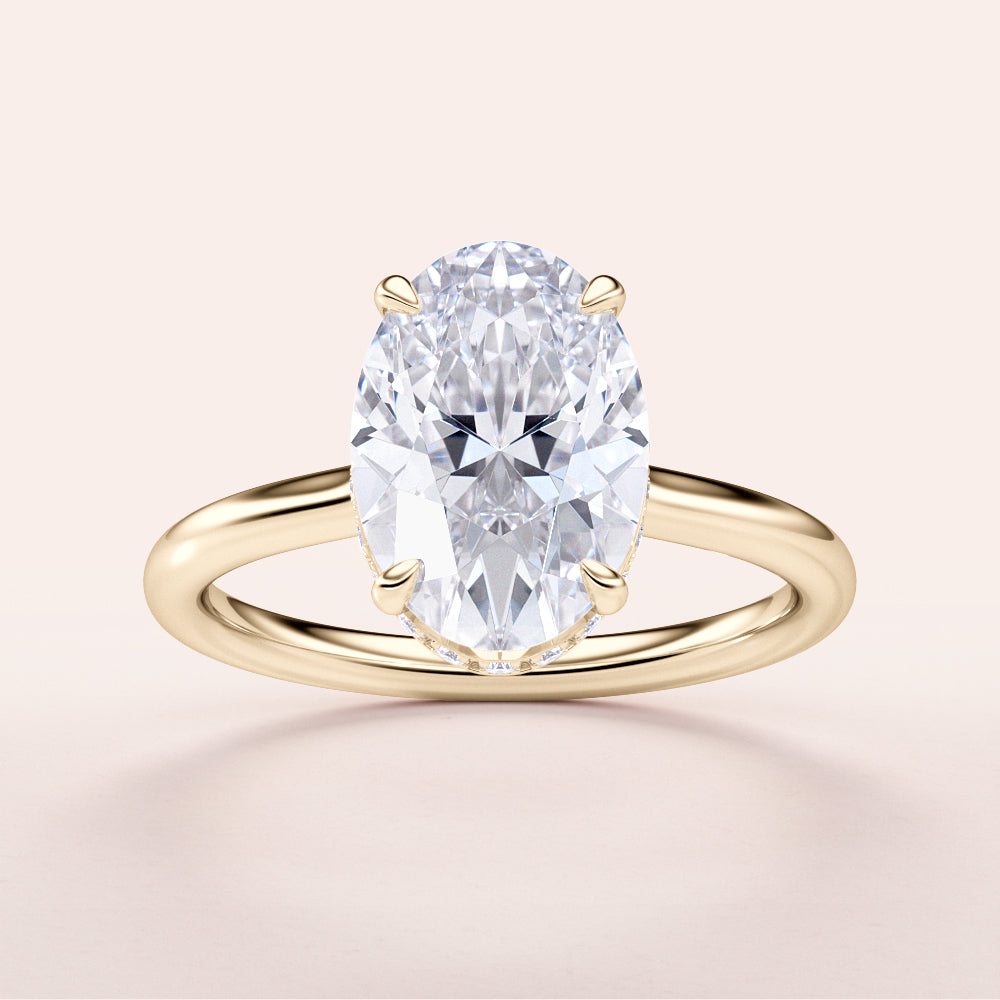 Elegant 14K yellow gold engagement ring with an oval diamond, showcasing timeless beauty in a hidden halo design.|
#14KRecycledYellowGold
#18KRecycledYellowGold